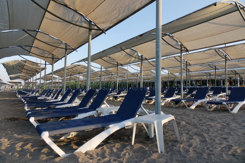 Sun Loungers with Umbrella on the Beach. Tourism Industry Stock Image ...