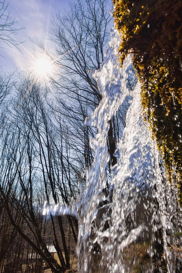 Sun over waterfall on Mostenica travertines in the Uhliarska dolina Valley in Low Tatras mountains
