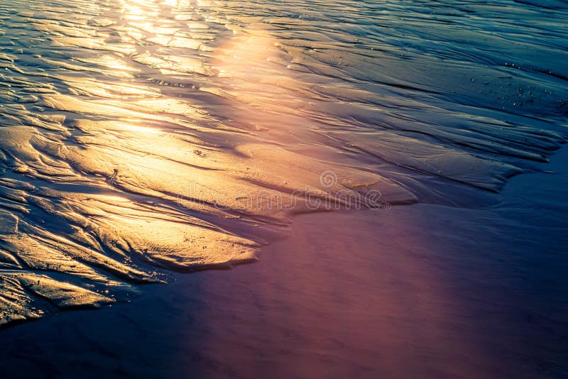 Sun patterns wet sand