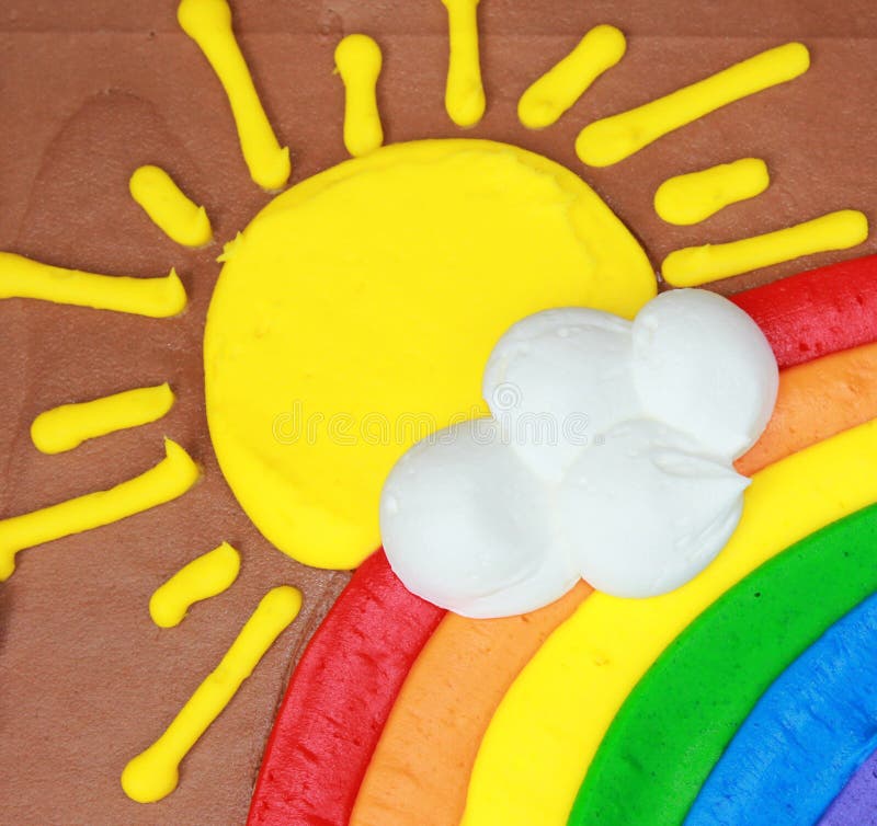 Cake frosting of bright shining sun, rainbow and white cloud. Cake frosting of bright shining sun, rainbow and white cloud.