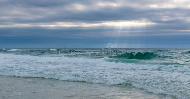 Sun rays break the clouds of a passing rain storm