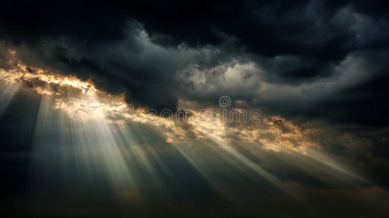 Sun rays piercing through dark dramatic clouds in a powerful natural scene royalty free stock image