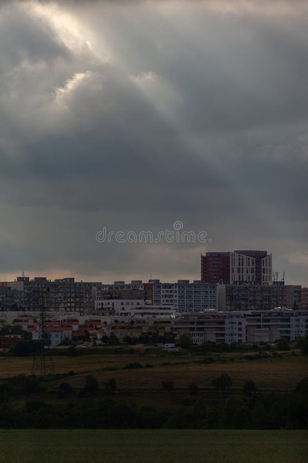 Sun rays piercing the gray clouds over the buildings in the Stodulky district of Prague stock images
