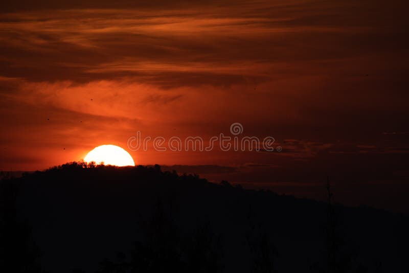 Sun rising from behind the mountain