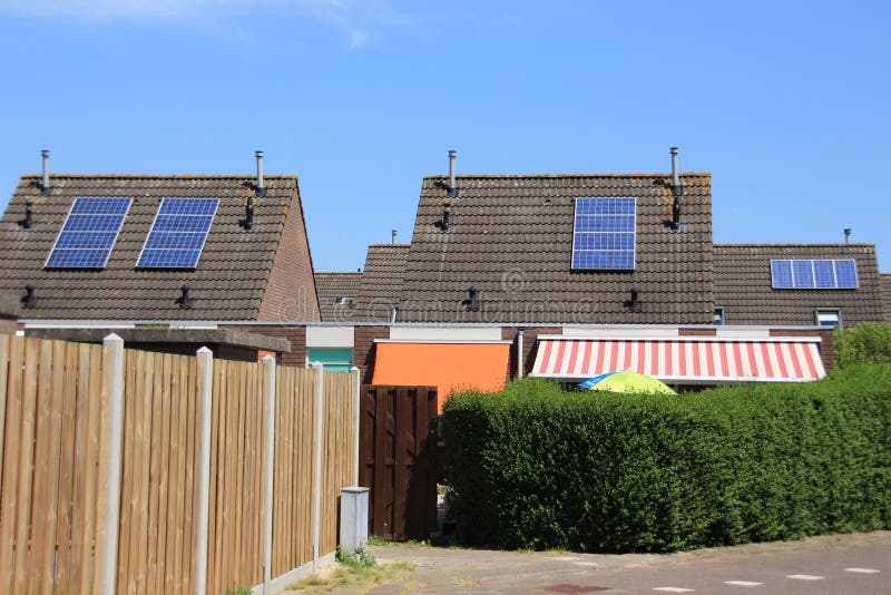 Solar panels on the roof of the houses in the summer.