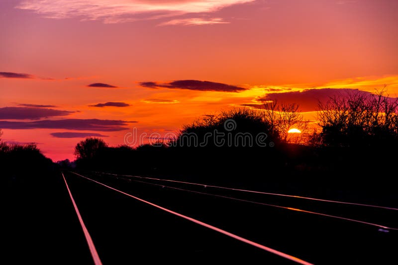 Sun set rise at railway tracks