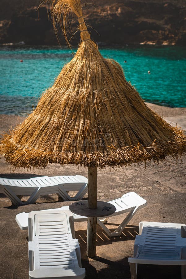 Straw Beach Umbrella and Loungers by Turquoise Mediterranean Sea Stock ...