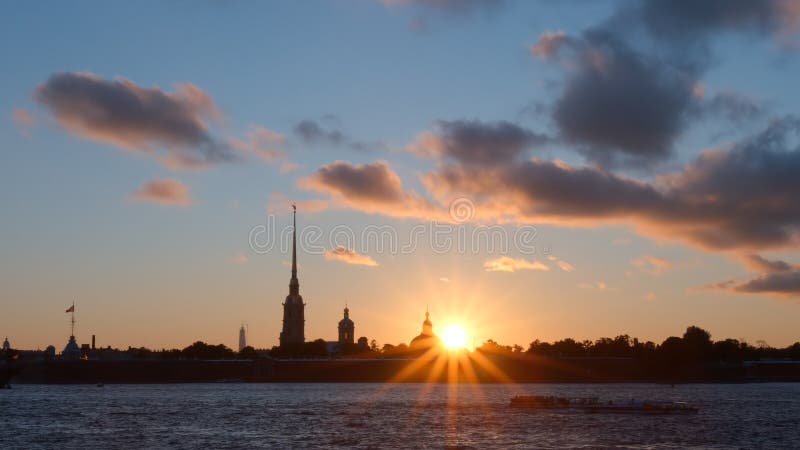 Sun and silhouette of Peter and Paul Fortress in the sunset - St. Petersburg, Russia