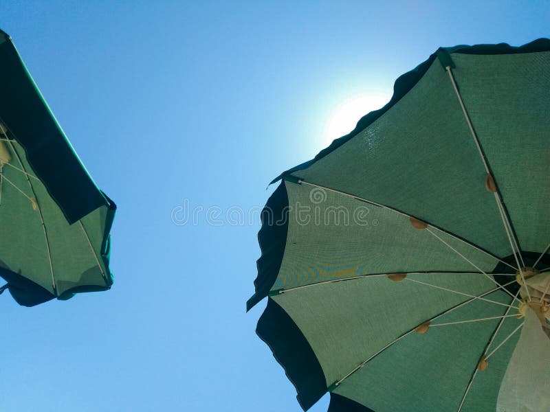 Sun Umbrellas, through Which the Sun Pierces Stock Photo Image of