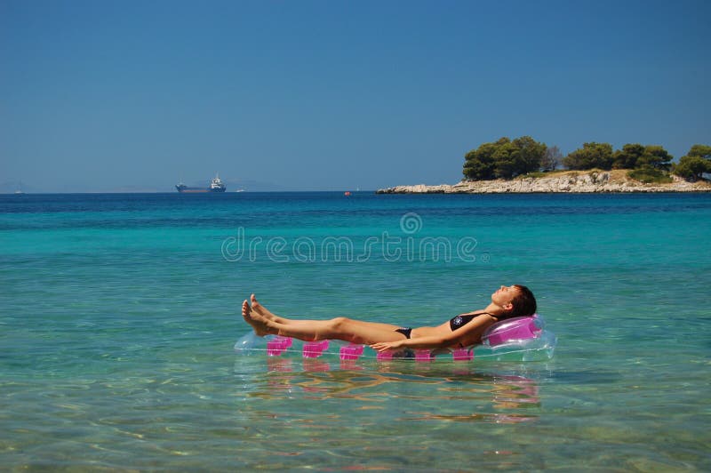 Gorgeous scenic view of young girl sunbathing on A