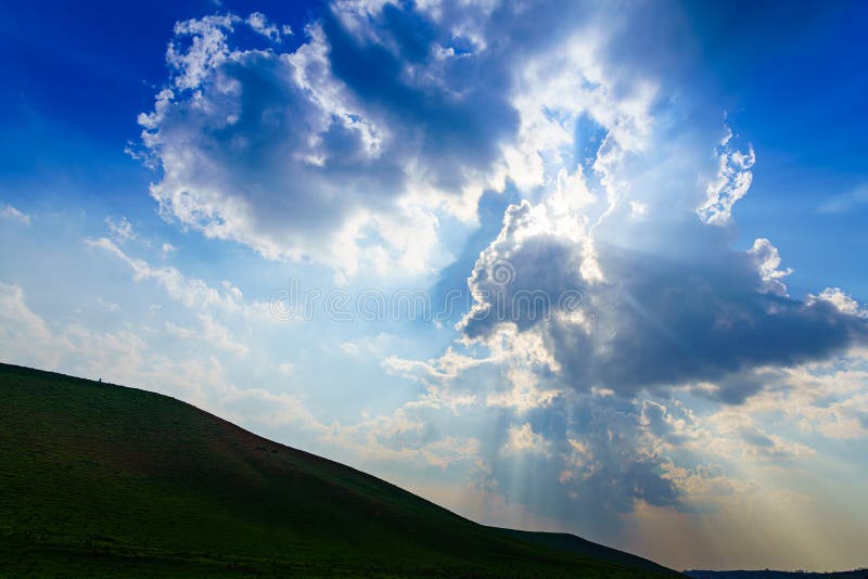 Sunbeams Breaking through Dramatic Cumulus Clouds. Change of Weather