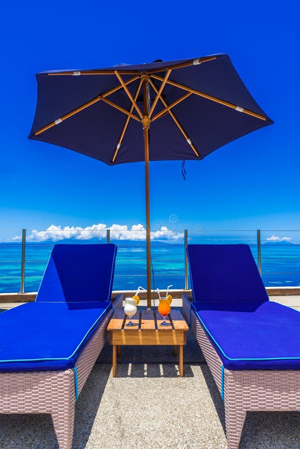 Sunbed on tropical beach stock photo. Image of palm 144056058