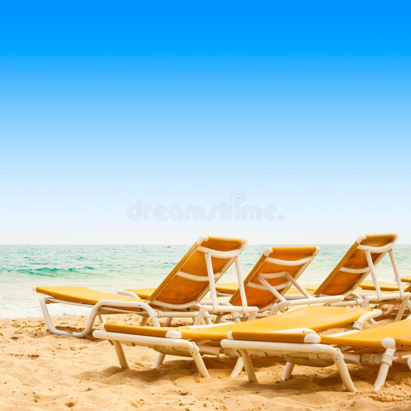 Sunbeds on the sandy beach stock photo. Image of summer 20756852