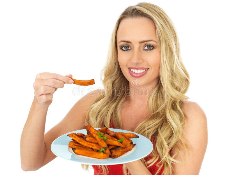 Happy Young Woman Holding a Plate of Roasted Sweet Potatoes. Happy Young Woman Holding a Plate of Roasted Sweet Potatoes