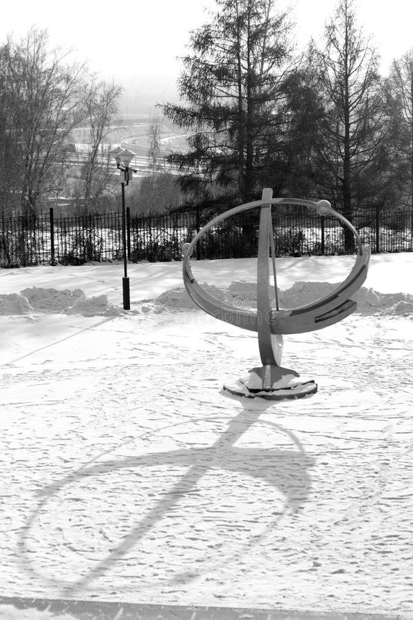 Sundial on snow winter background