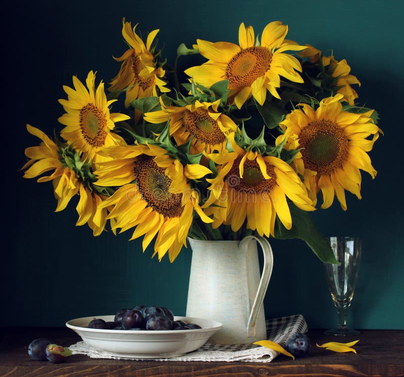 Sunflowers and plums. bouquet of garden flowers and berries