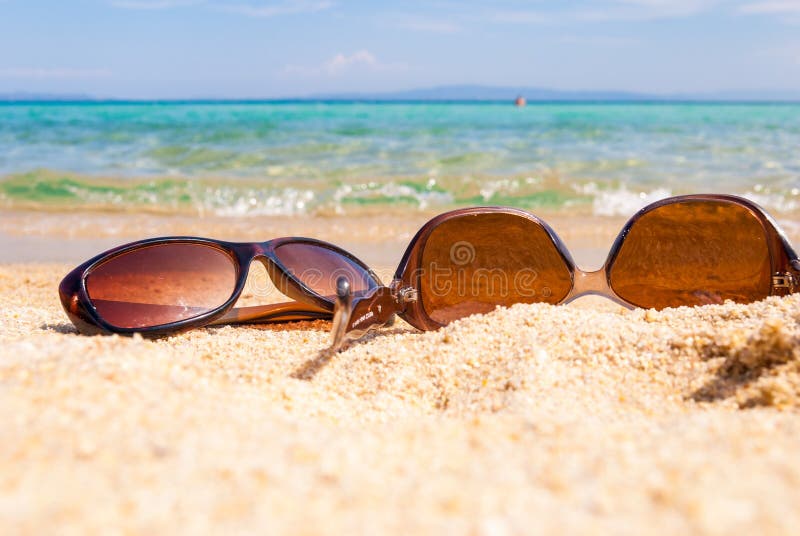 Sunglasses on the Beach Near the Sea Against the Sea Wave Stock Image ...