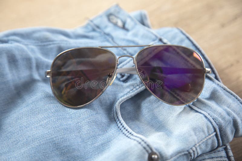 Sunglasses on the jeans stock image. Image of fashion 232022381