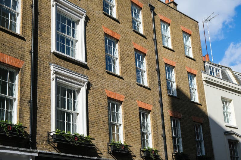 A Row of Brick Buildings with Black Doors on a Street in London Stock Image  - Image of architecture, english: 189002149