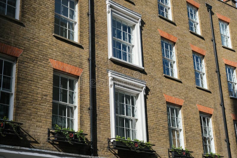 A Row of Brick Buildings with Black Doors on a Street in London Stock Image  - Image of architecture, english: 189002149