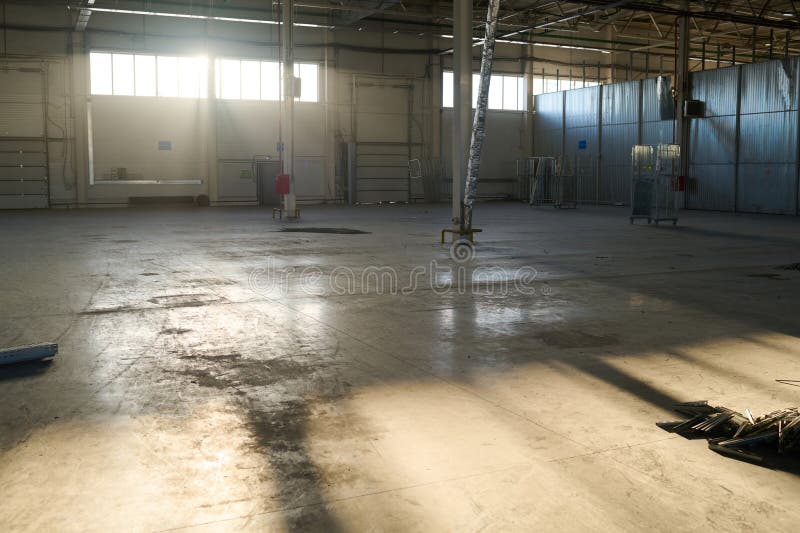 Sunlit corner of spacious workshop or warehouse of industrial plant royalty free stock photos
