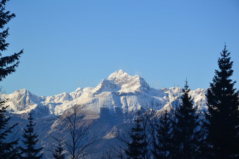 Sunlit mountain peak in winter