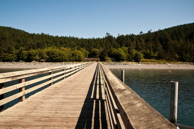 Sunlit pier in Washington state. Boardwalk rail stock images, royalty-free photos and pictures