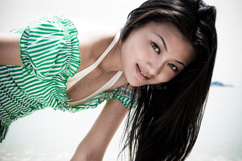 Sunny asian girl in green with long black hair