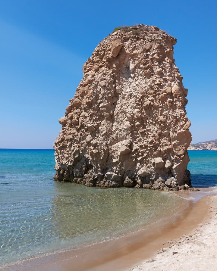 Sunny beach and huge rock