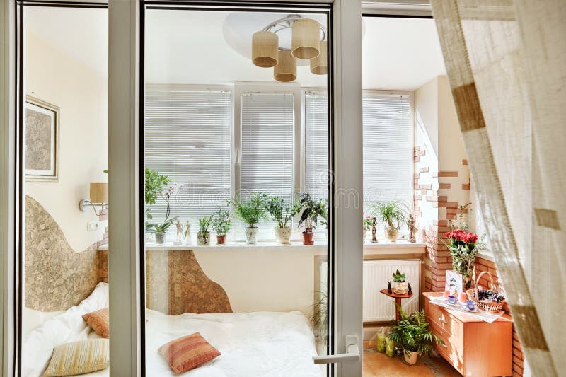 Sunny bedroom interior view through the balcony door