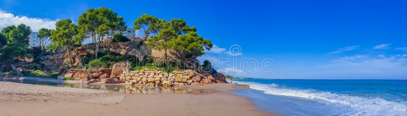 Sunny costa dorada panorama. Beautiful sea bay under clear blue sky. Spain