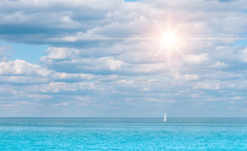 sunny day with a boat floating on the sea