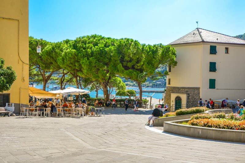 A sunny day on the Ligurian Coast as tourists enjoy cafes and relaxation on the Piazza Bastreri in Portovenere Italy. A sunny day on the Ligurian Coast as royalty free stock photo A sunny day on the Ligurian Coast as tourists enjoy cafes and relaxation on the Piazza Bastreri in Portovenere Italy. A sunny day on the Ligurian Coast as royalty free stock photo