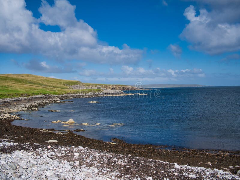 On a sunny day in summer, a view of the scenic, deserted coastline near Aywick on the east of the island of Yell in Shetland