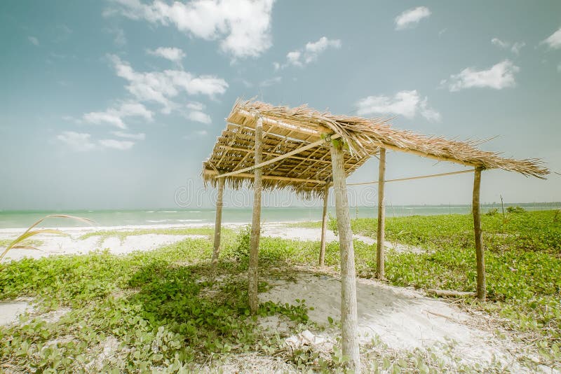 Sunny day at tropical beach with fisherman hut. Myanmar (Burma)