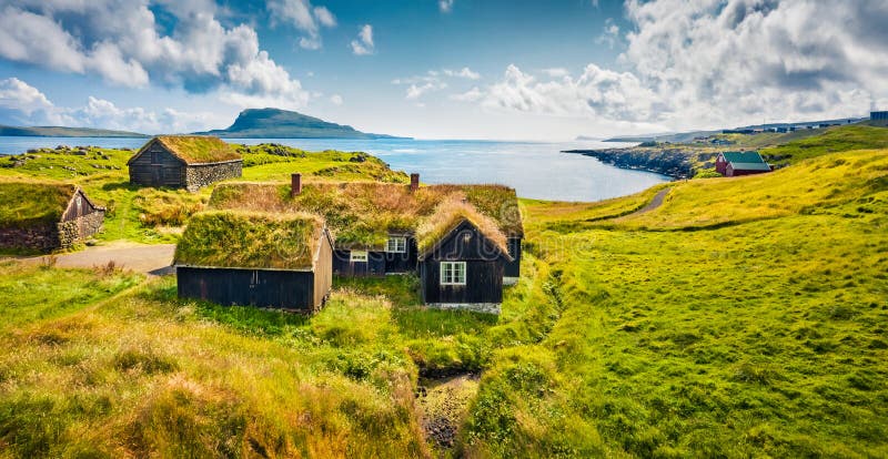 Sunny morning view of typical turf-top houses. Panoramic summer scene of outskirts of Torshavn city, capital of Faroe Islands, Kin