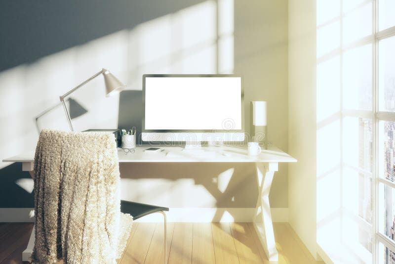 Sunny white room with blank screen monitor of computer