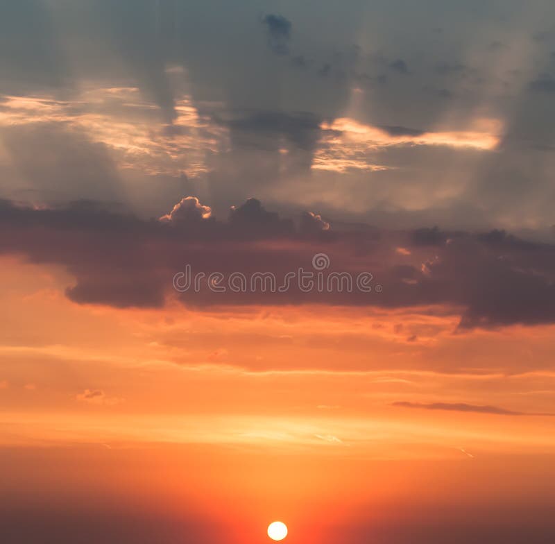 Sunrise in autumn, the rising sun over the horizon, the rays piercing the clouds and the sky. stock photo