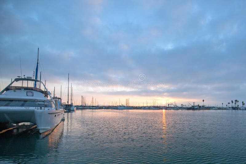 Sunrise boat reflections over Channel Islands harbor at Oxnard on the gold coast of California United States