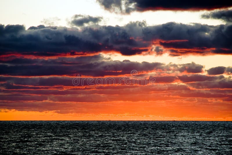 Sunrise with dark dramatic clouds in miami beach stock photo