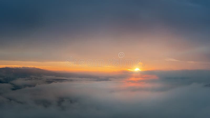 Sunrise high above the clouds with the sun