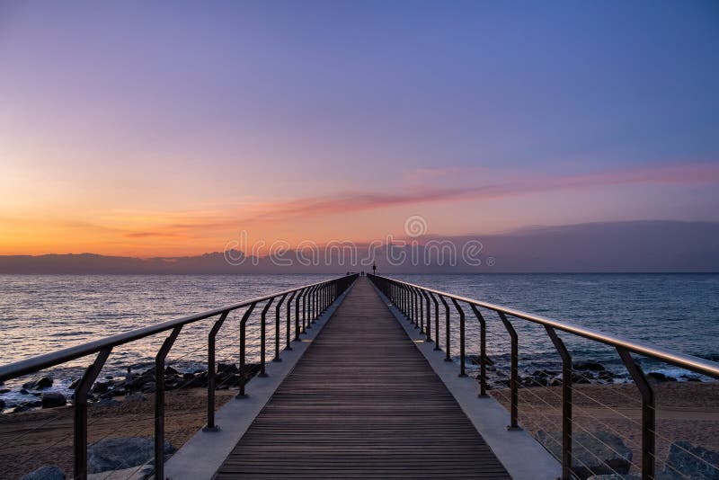 Sunrise in a mediterranean harbor on pontoon - Pont del Petroli, Badalona, Barcelona, Catalonia, Spain