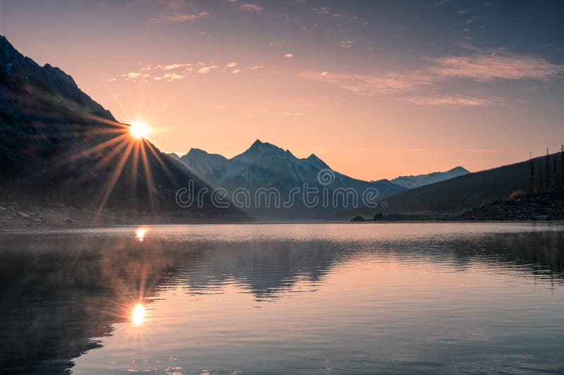 Sunrise on mountain with foggy in Medicine lake at Jasper