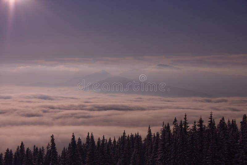 Winter landscape, sunrise in mountains in winter, misty morning