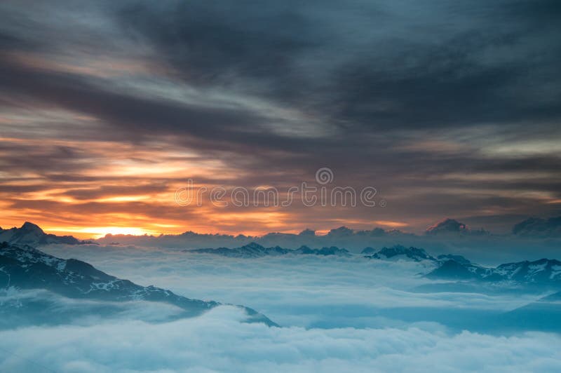 Sunrise over the clouds and peaks of wallis alps