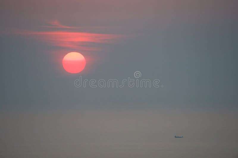 Red and foggy sunrise over small fishing boat. Red and foggy sunrise over small fishing boat.