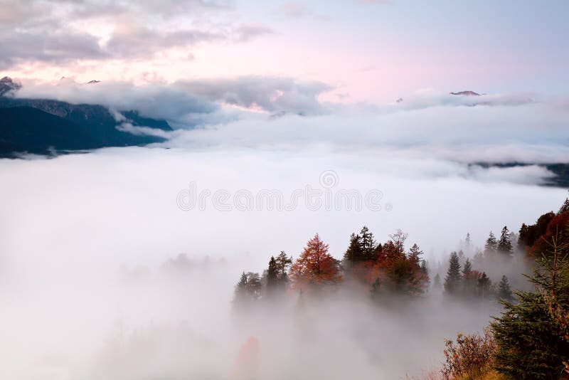 Sunrise over fog in Alps