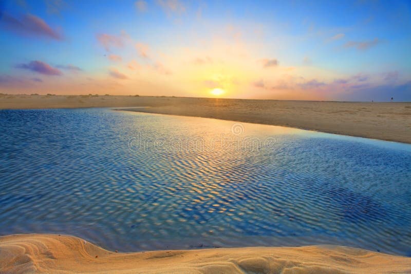 Sunrise over golden sands and azure waters royalty free stock images Sunrise over golden sands and azure waters royalty free stock images