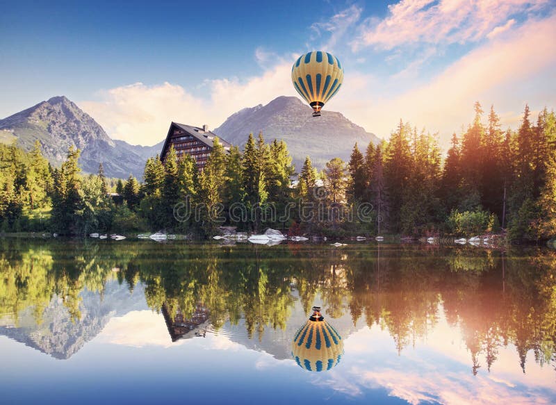 The sunrise over a lake in the park High Tatras. Shtrbske Pleso, Slovakia, Europe.