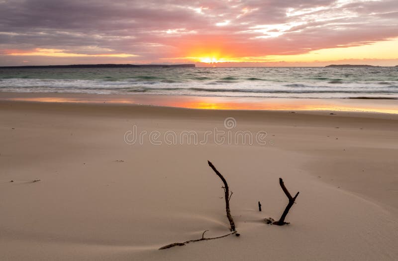 Sunrise over the ocean with beautiful unspoilt beach stock photo Sunrise over the ocean with beautiful unspoilt beach stock photo